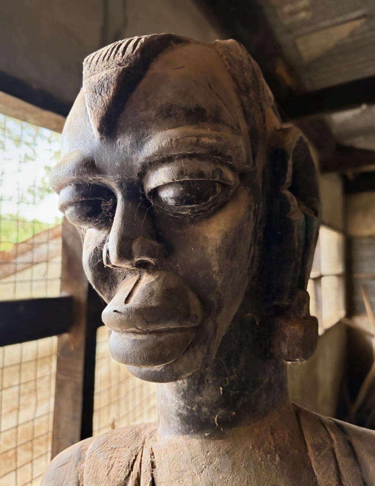 A carved head with a crested crown and lidded eyes