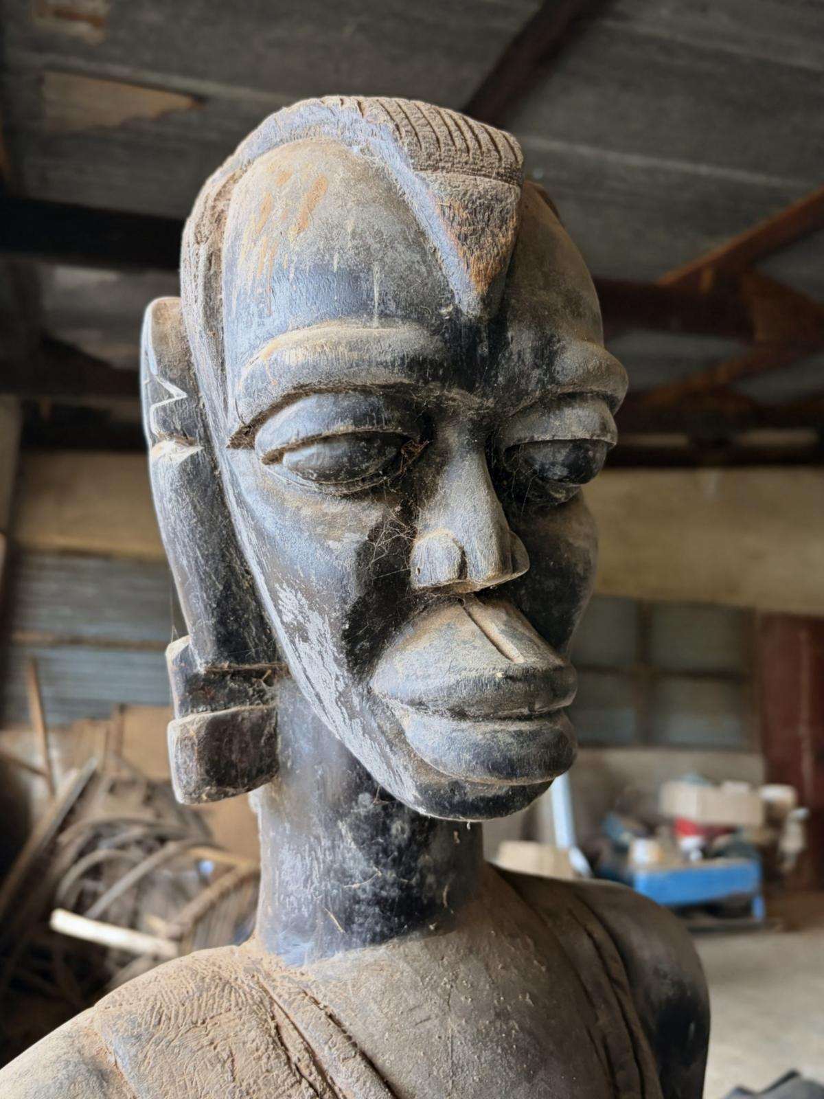 A carved face with combed crown ridges and lidded eyes